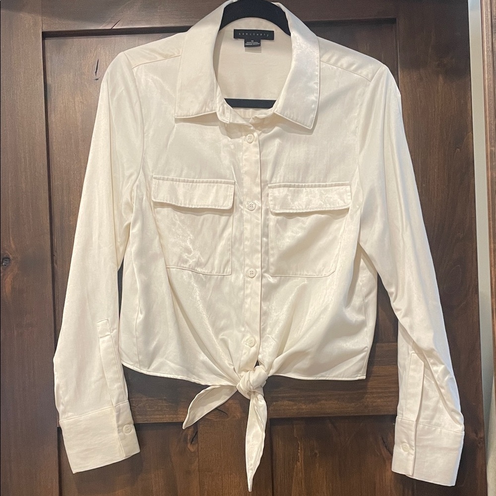 Sanctuary size medium ivory colored blouse with tie bottom.